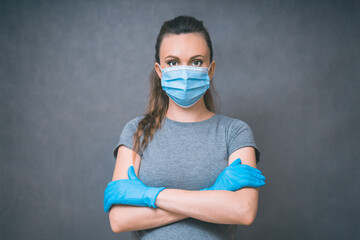 Yang woman in blue gloves and Medical Face Mask against flu and viruses. Healthcare And Infection concept.