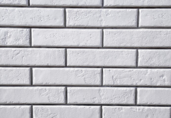 White brick wall background. Textured white clean brick wall, background with copy space. Texture of white wall facade background close up.