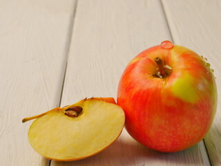 Naklejka na ściany i meble Two red ripe apples on a white wooden background. Proper nutrition. Lifestyle. Close- up. Space for text