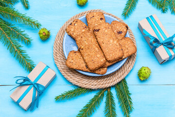 Delicious prepared cookies for Christmas next to gifts and fir cones.