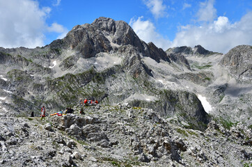 Tourists in the mountains of Abkhazia in summer in sunny day