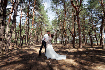 the bride and groom are walking in the woods