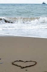 drawing of a heart on the sand of a beach - love