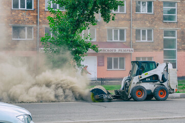 Improper cleaning of the road with a special machine. Very dusty and dirty