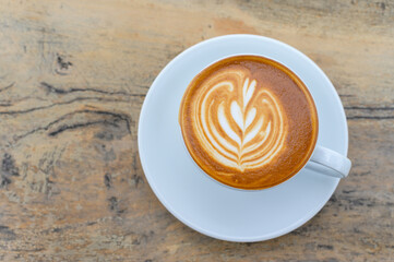 Latte art coffee cup on wooden table, Flat lay