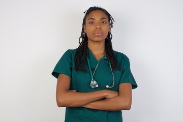 Picture of angry young beautiful woman standing isolated over bright background. Looking camera.