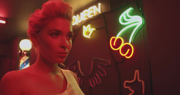 portrait of a beautiful girl in red light. neon light, impregnable look