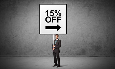 Obraz premium business person holding a traffic sign with 15% OFF inscription, new idea concept