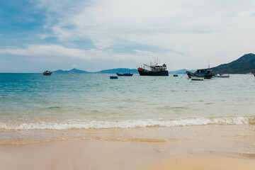 Fishing ships in Vietnam are anchored in a calm bay after a night out to sea