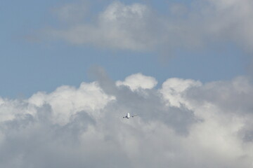 an airplane flying in the sky with cloud
