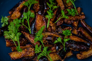 fried eggplant with parsley on a plate