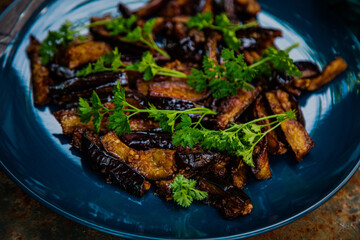 fried eggplant with parsley on a plate