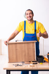 Young male carpenter working indoors