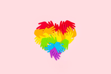 Pride, LGBT flag symbol concept with rainbow color palm hands heart butterfly shape on pink background with copy space