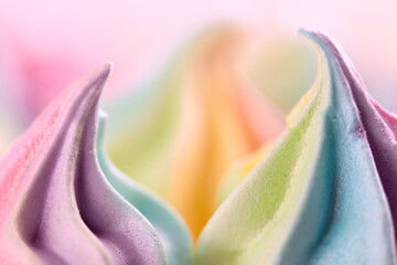 Closeup of sweet rainbow color and twisted meringue cookies. Concept of sweet food. Macro, soft focus