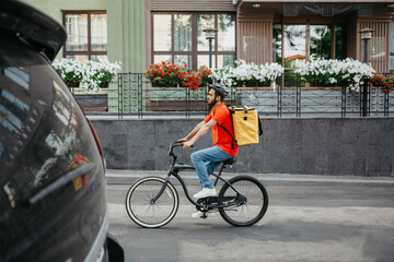 Working day courier in city. Young man in safety helmet with backpack rides on bicycle at road