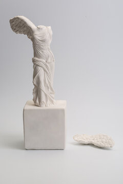 Greek goddess of victory sculpture on white background

