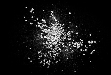 Obraz premium Close-up of macro crystals of sea salt or coarse salt isolated on black background