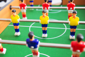 Fototapeta premium Table football game with yellow and red players and white goalkeeper.