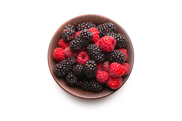 Raspberry, blackberry and mint leaf in ceramic brown bowl isolated on white