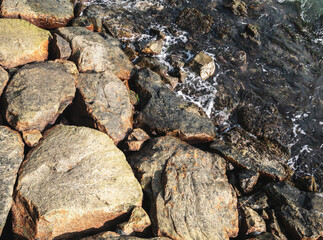 Waters of lake washing up on the rocky shore.