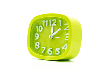 Beautiful green modern alarm clock closeup isolated on white background
