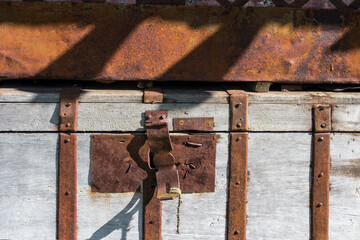 Old metal padlock on a wooden door of barn