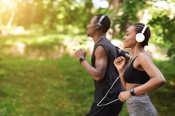 Morning Run Concept. Sporty Black Man And Woman Jogging Outdoor In Park