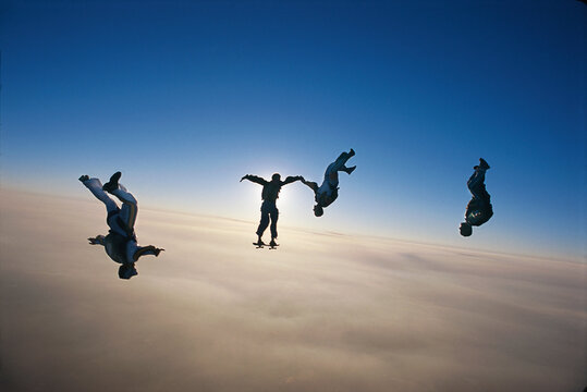 Skydiving Group Of People Above The Clouds