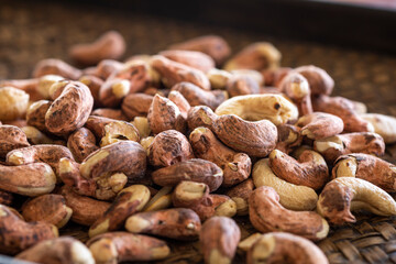 close up traditional roasted cashew nuts in wicker tray