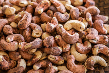 close up traditional roasted cashew nuts in wicker tray