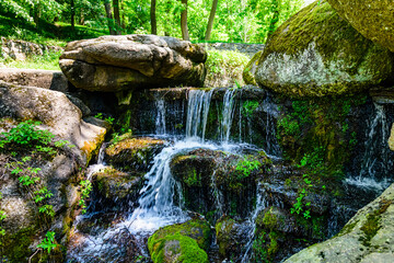 Beautiful waterfall on small river in a park
