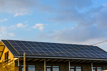 Fototapeta premium Solar panels on roof of residential house. Clean energy. Ecological concept