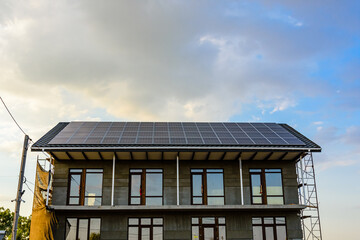 Fototapeta na wymiar Solar panels on roof of residential house. Clean energy. Ecological concept