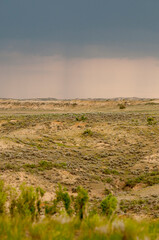 Obraz premium rain sweeping over the badlands in south dakota