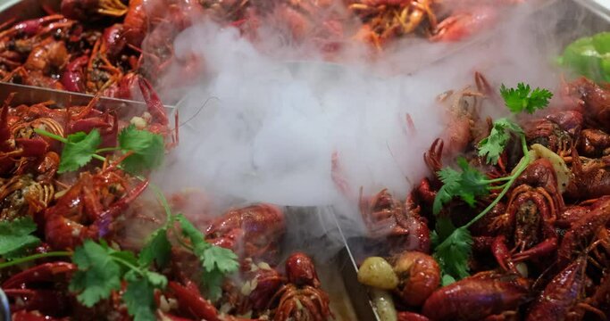 close up many steamed spicy Red Swamp Crayfish in big pot. popular food in China.