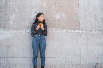 Asian woman using her mobile phone.