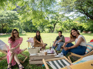 people on canvas chair in garden having afternoon tea and relaxing.