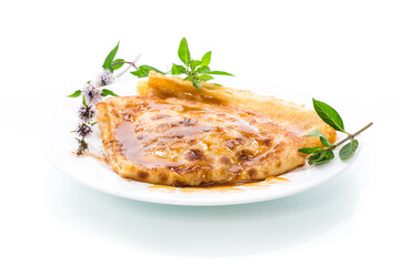 fried thin pancakes with sweet caramel in a plate