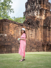 Asian woman tourist in pink dress with medical face mask at 