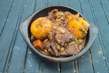 Stewed meat with carrots, potatoes, peas and thyme