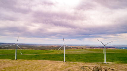Fototapeta na wymiar Wind farm with three turbines in a row