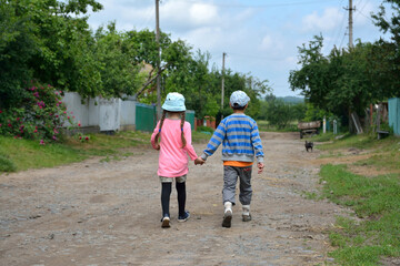boy and girl go holding hands