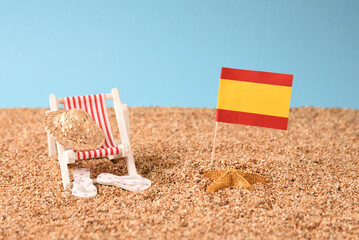 Sunbed on the beach with Spanish flag.