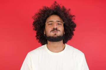 Handsome young man puffing cheeks with funny face. Mouth inflated with air, crazy expression.