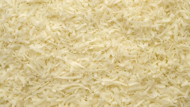 cheese parmesan grated close up, rotating