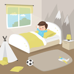 Obraz premium Happy boy lies in bed. Cute male kid wakes up in the morning in her bedroom.