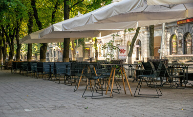 Closed sidewalk cafe and deserted morning street of the ancient city