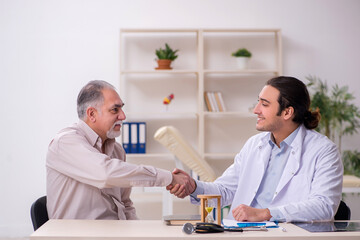 Old male patient visiting young doctor in time management concep