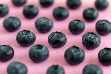 Fresh organic blueberries on pink background, macro